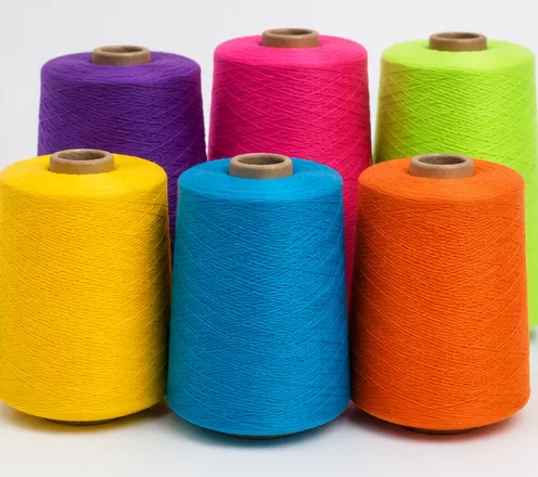 Brightly coloured polyester-cotton PC yarn cones
